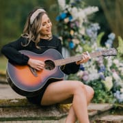 Abi outside on guitar